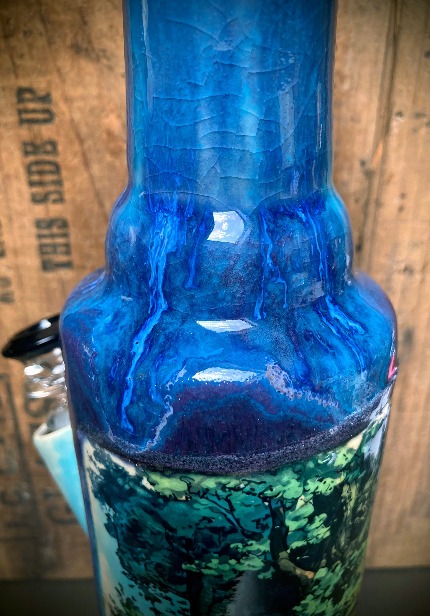 Side view highlighting vibrant blue glazes and flowing color gradients.