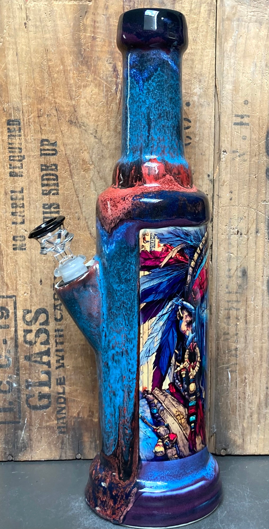 Artistic details of the Savage Chief bong highlighting tribal beadwork and feathers.