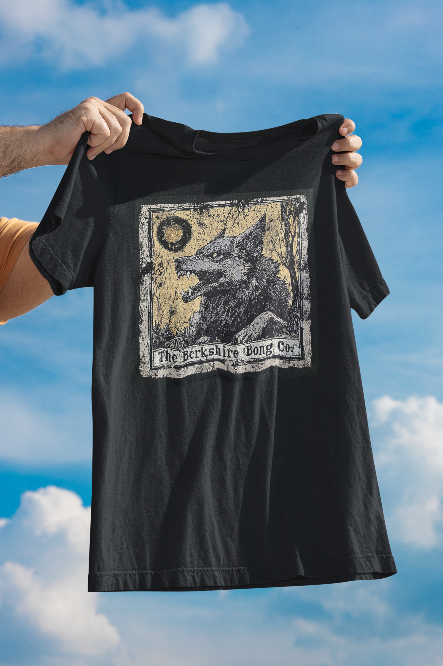 Black Berkshire Bong Company Big Bad Wolf Graphic Tee with wolf design held against blue sky