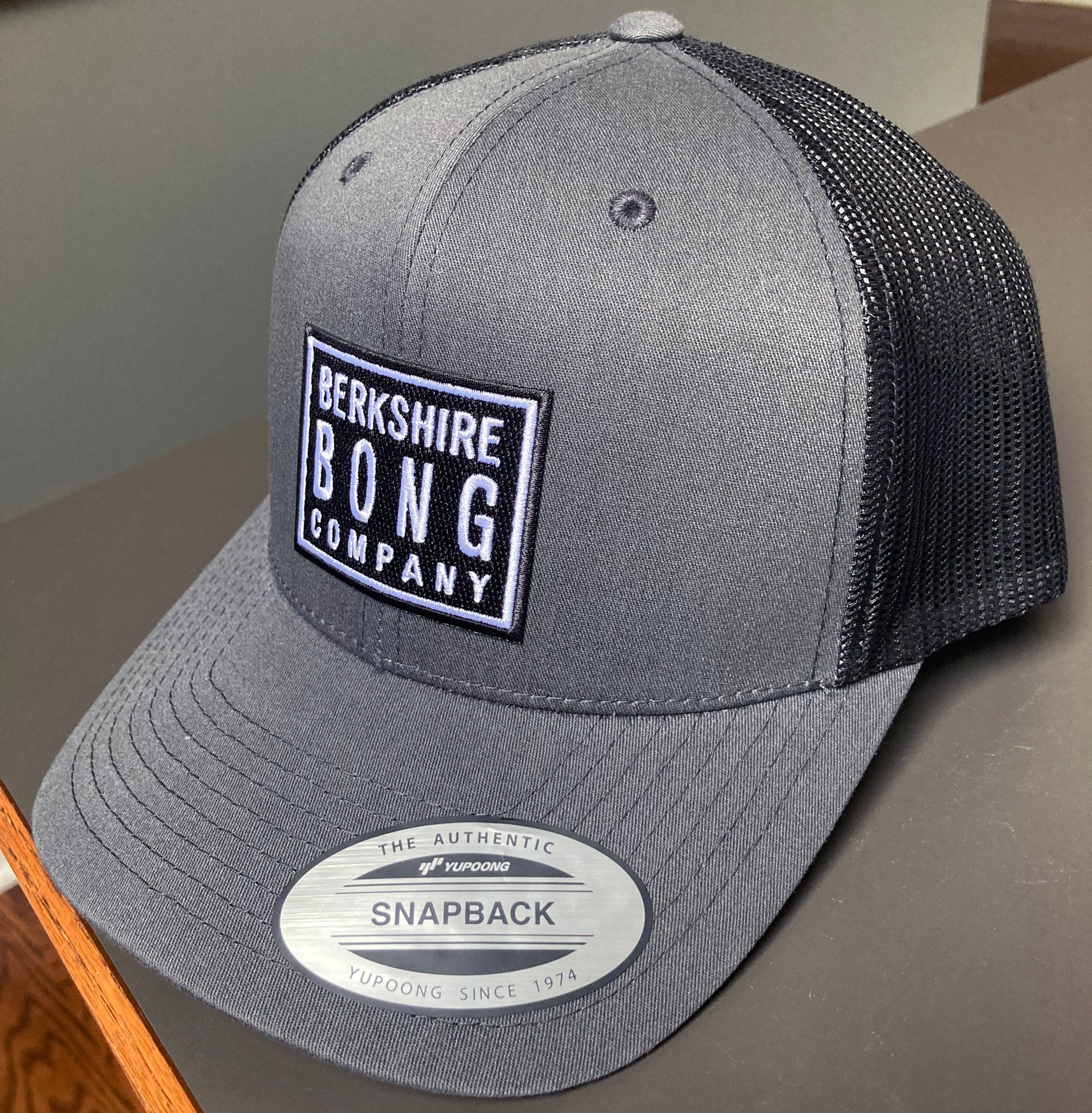 Berkshire Bong Company Trucker Hat in gray with mesh back and patch logo for outdoor style