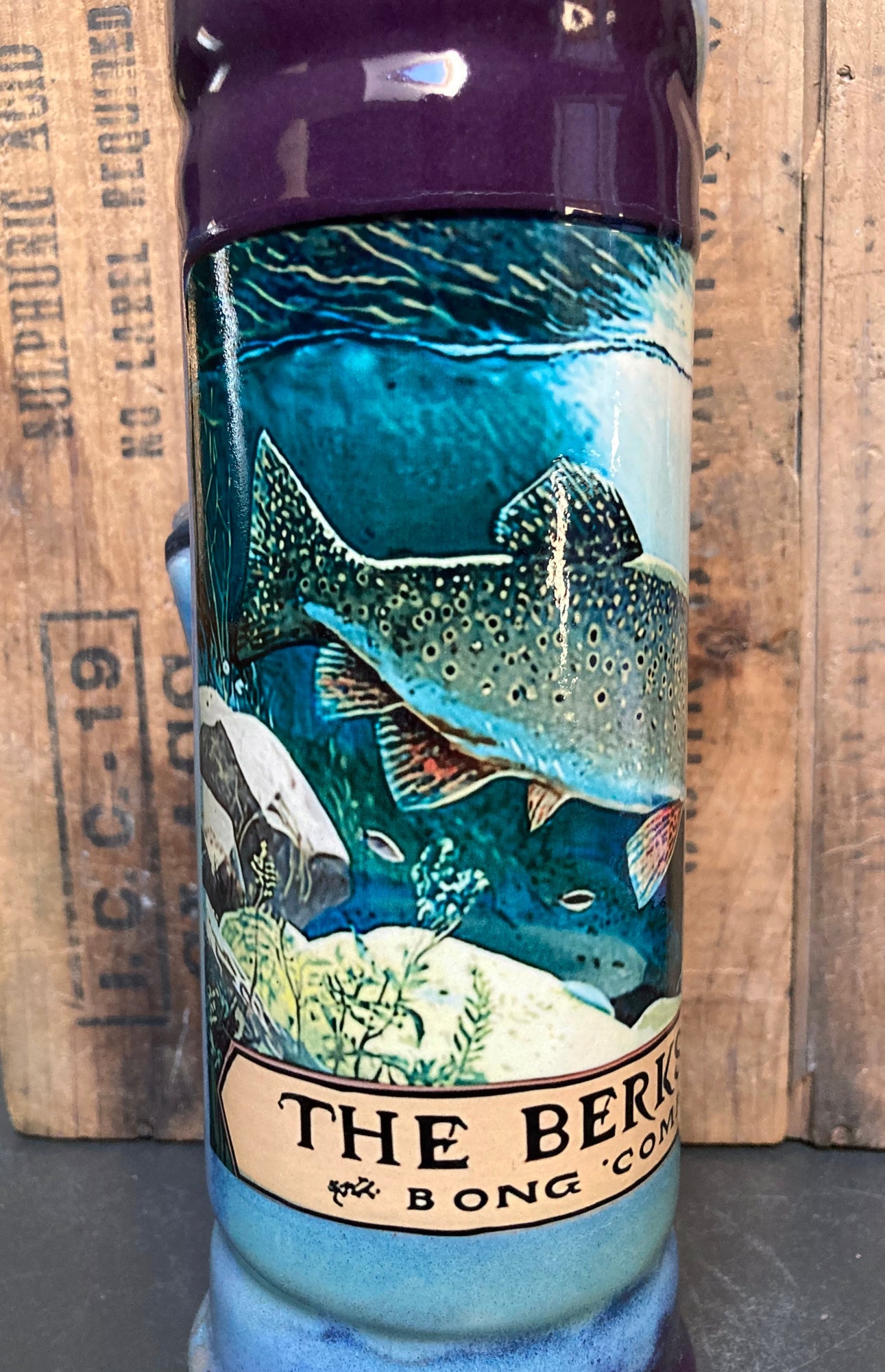 Brook trout ceramic bong with river and stream backdrop illustration.