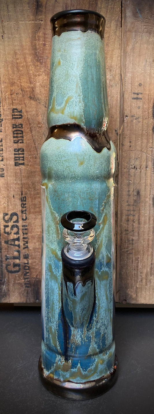 Ceramic bong showing River Queen with earthy green and golden hues.