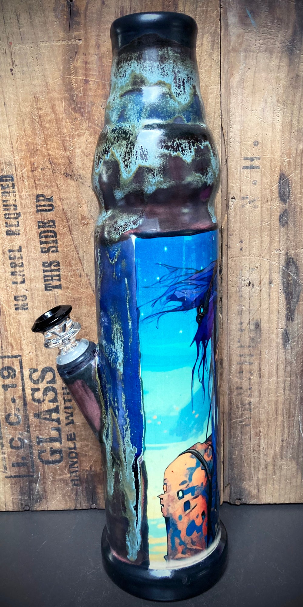 Ceramic bong showing celestial tribal warrior in glossy blue and silver tones.