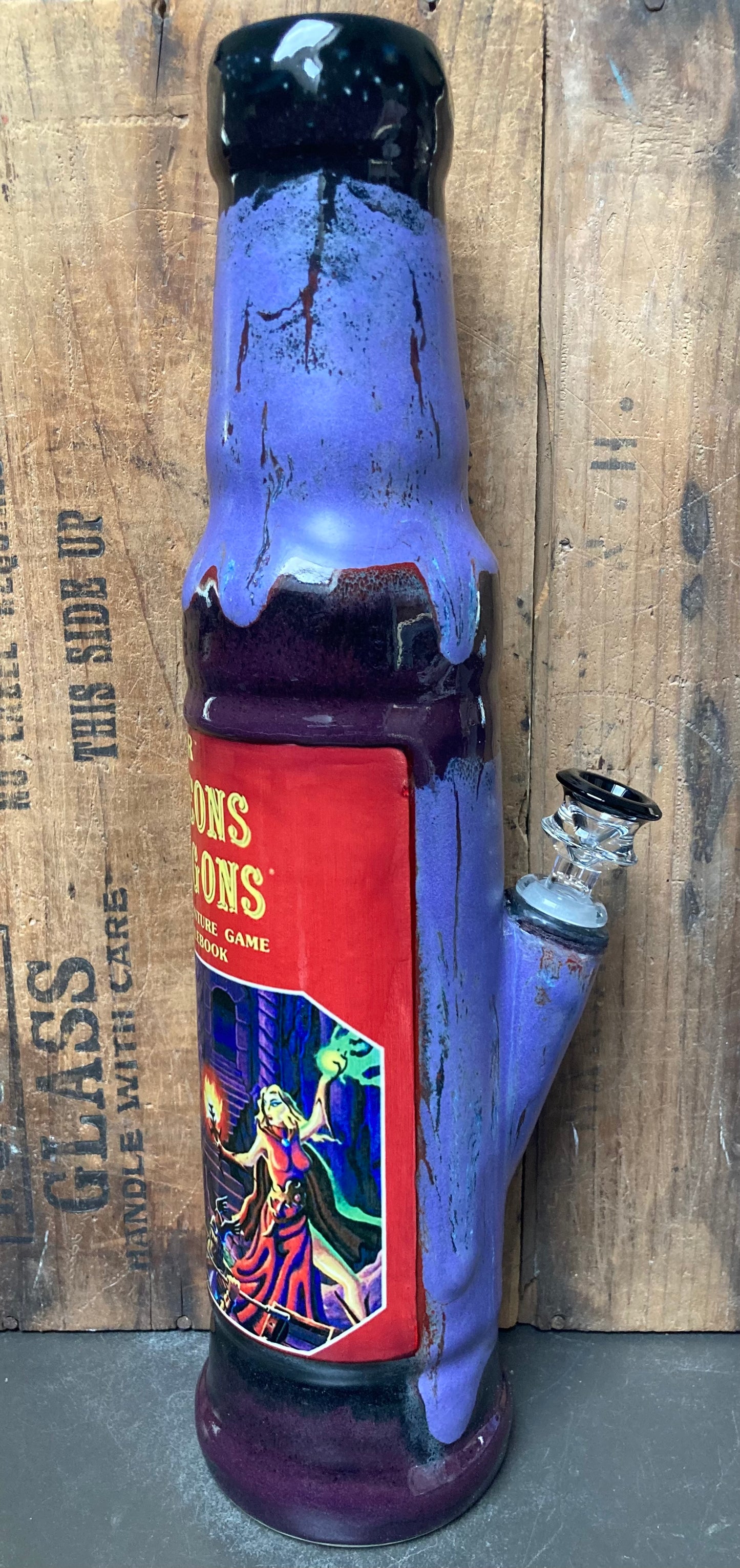 Colorful ceramic bong featuring Dungeons And Dragons rulebook design for collectors and enthusiasts
