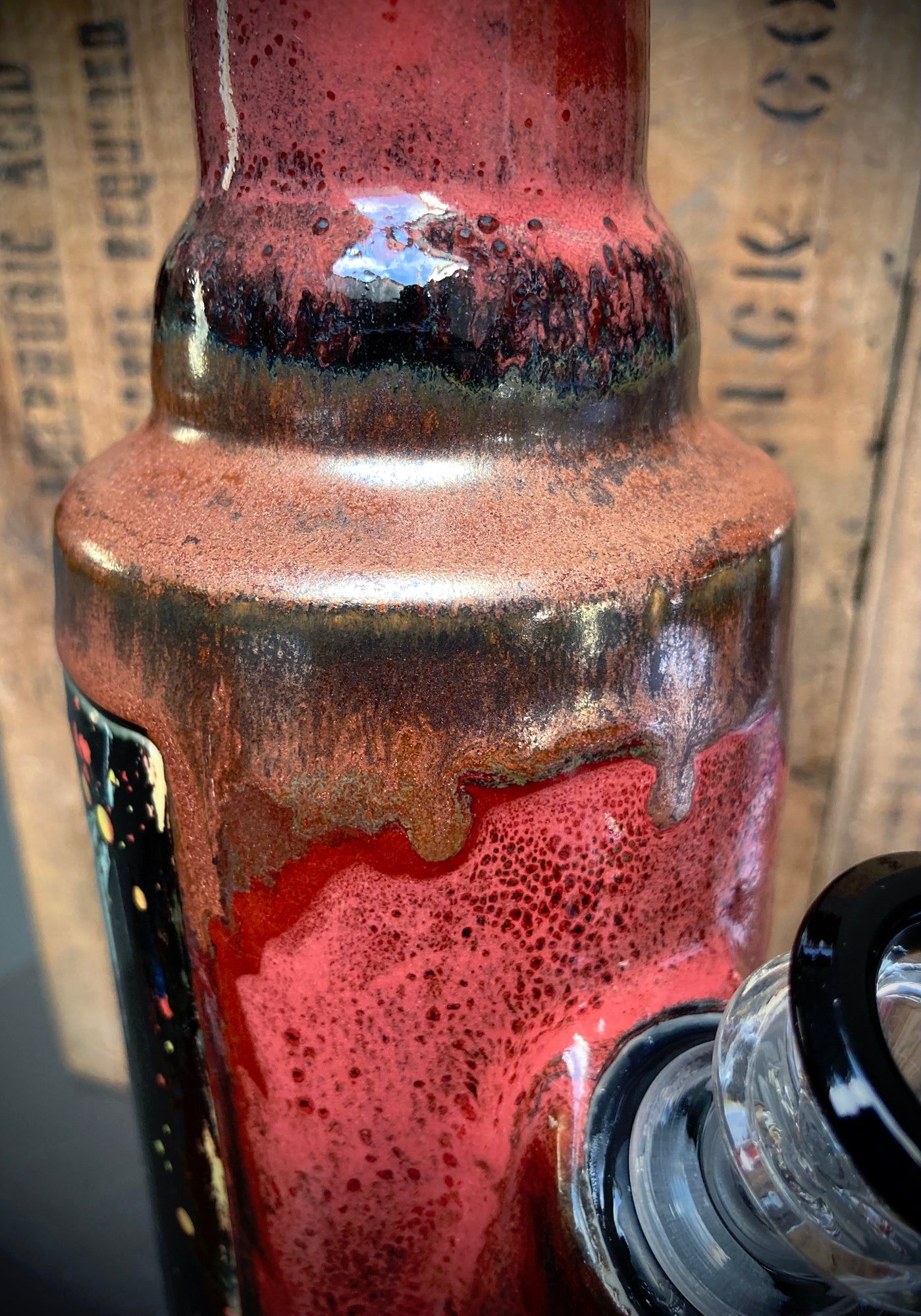 Close-up of a red ceramic bong featuring magic mushrooms shrooms design with intricate details