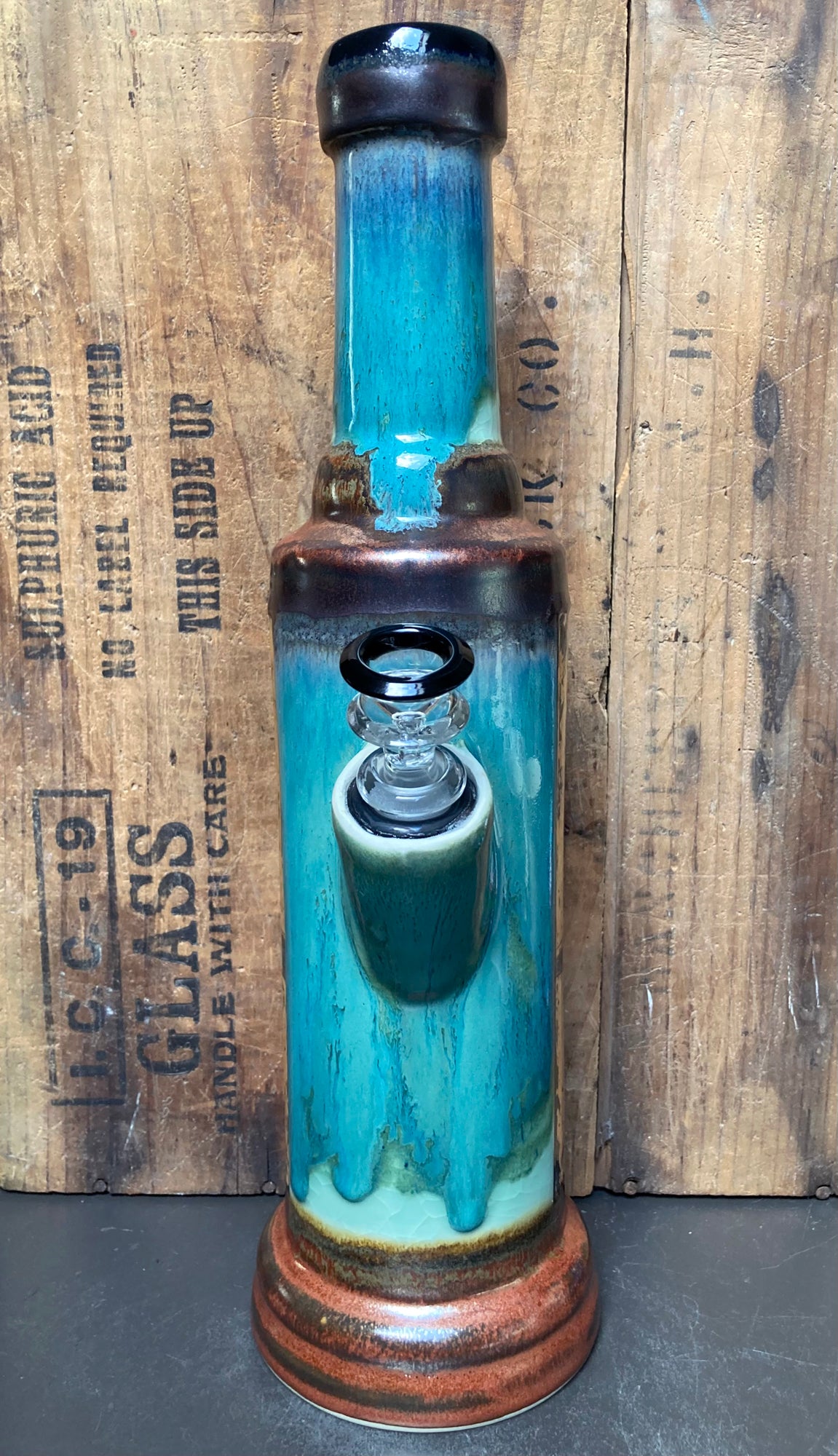 Detailed illustration of vintage turquoise airplane on ceramic bong with golden sky background.