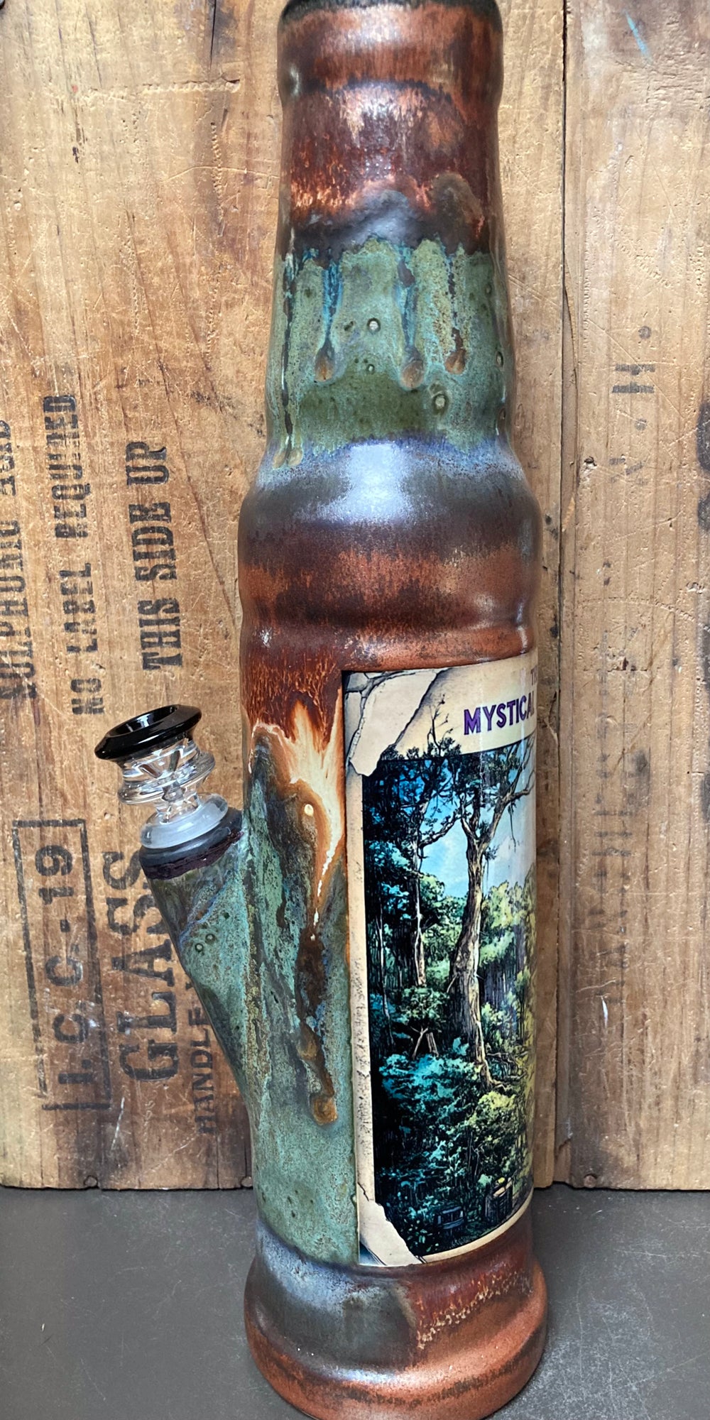 Unique ceramic bong with mystical Berkshire Hills art and a sleek bottle design