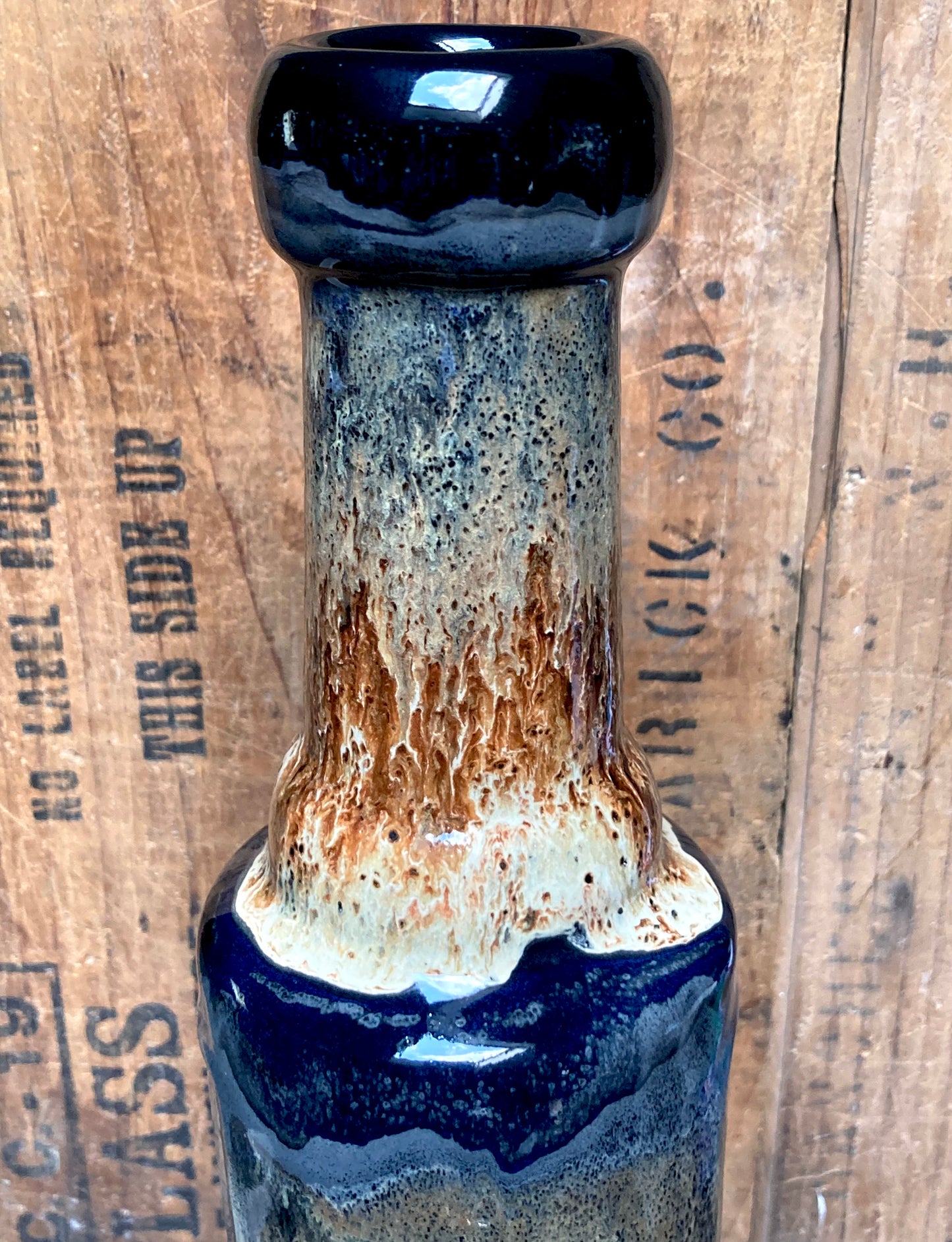 Front view of handmade ceramic wolf bong showing glossy black rim