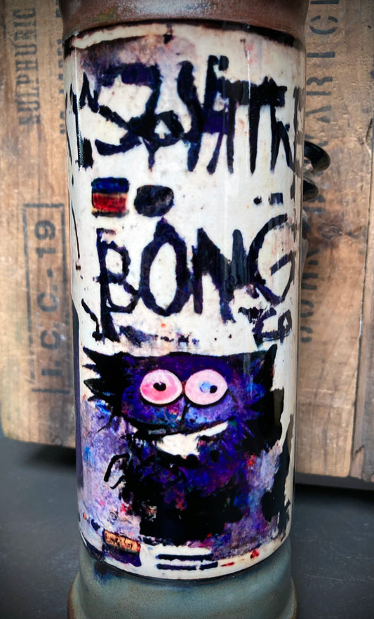 Graffiti-tagged ceramic bong with playful critter and antique copper accents.