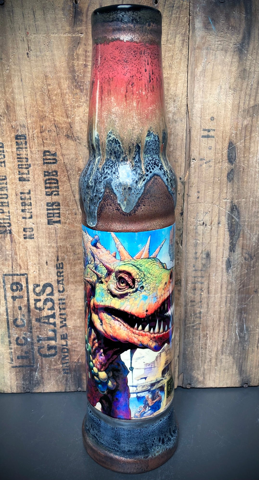 Jungle-themed bong with dinosaurs and fiery red-orange-green glaze mix.