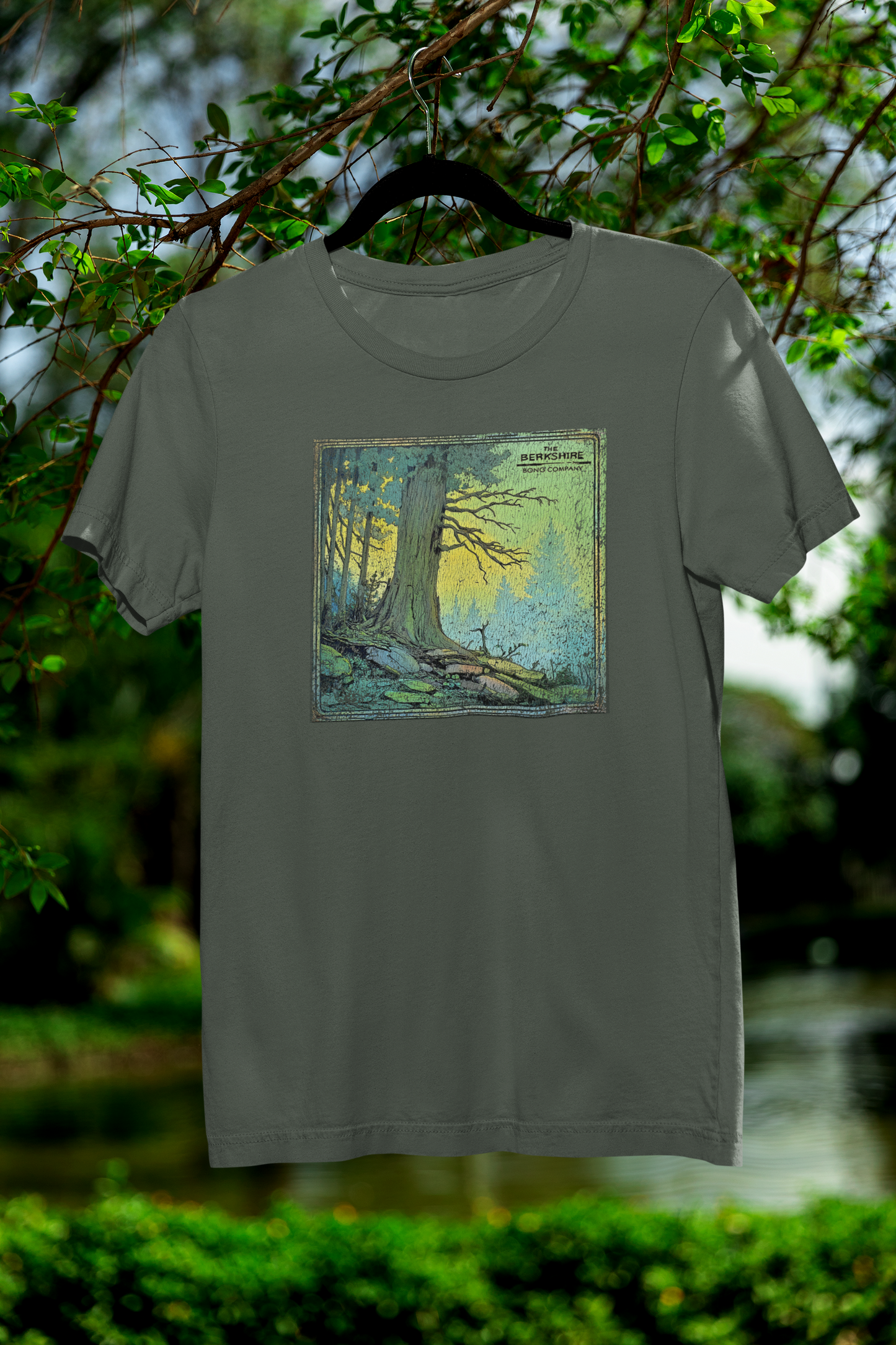 Distressed tree art on military green t-shirt with sunrise glow and cracked vintage print