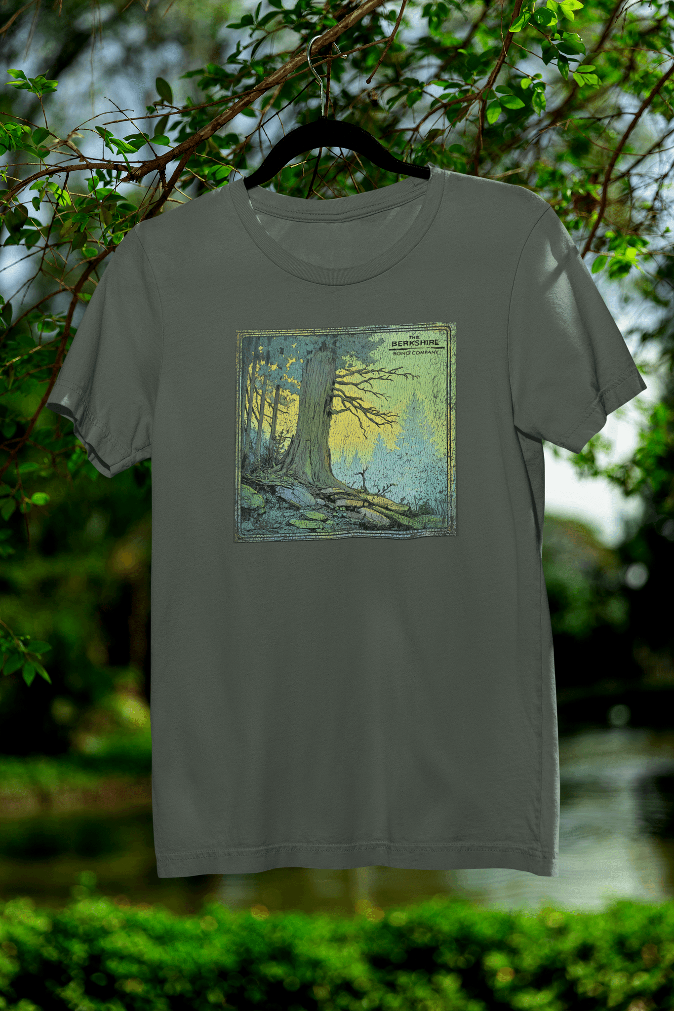 Distressed tree art on military green t-shirt with sunrise glow and cracked vintage print