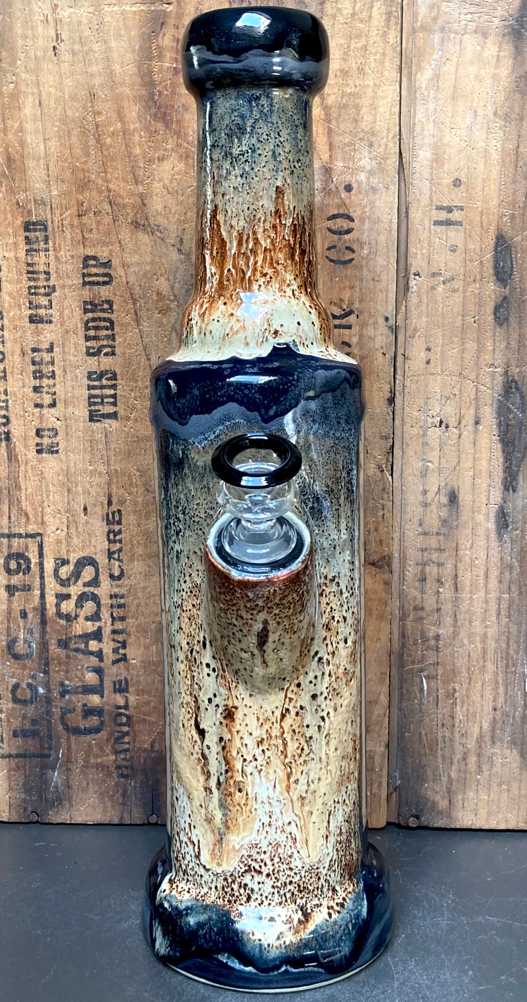Neck detail showing charcoal to cream gradient with glossy black lip and copper waterfalls