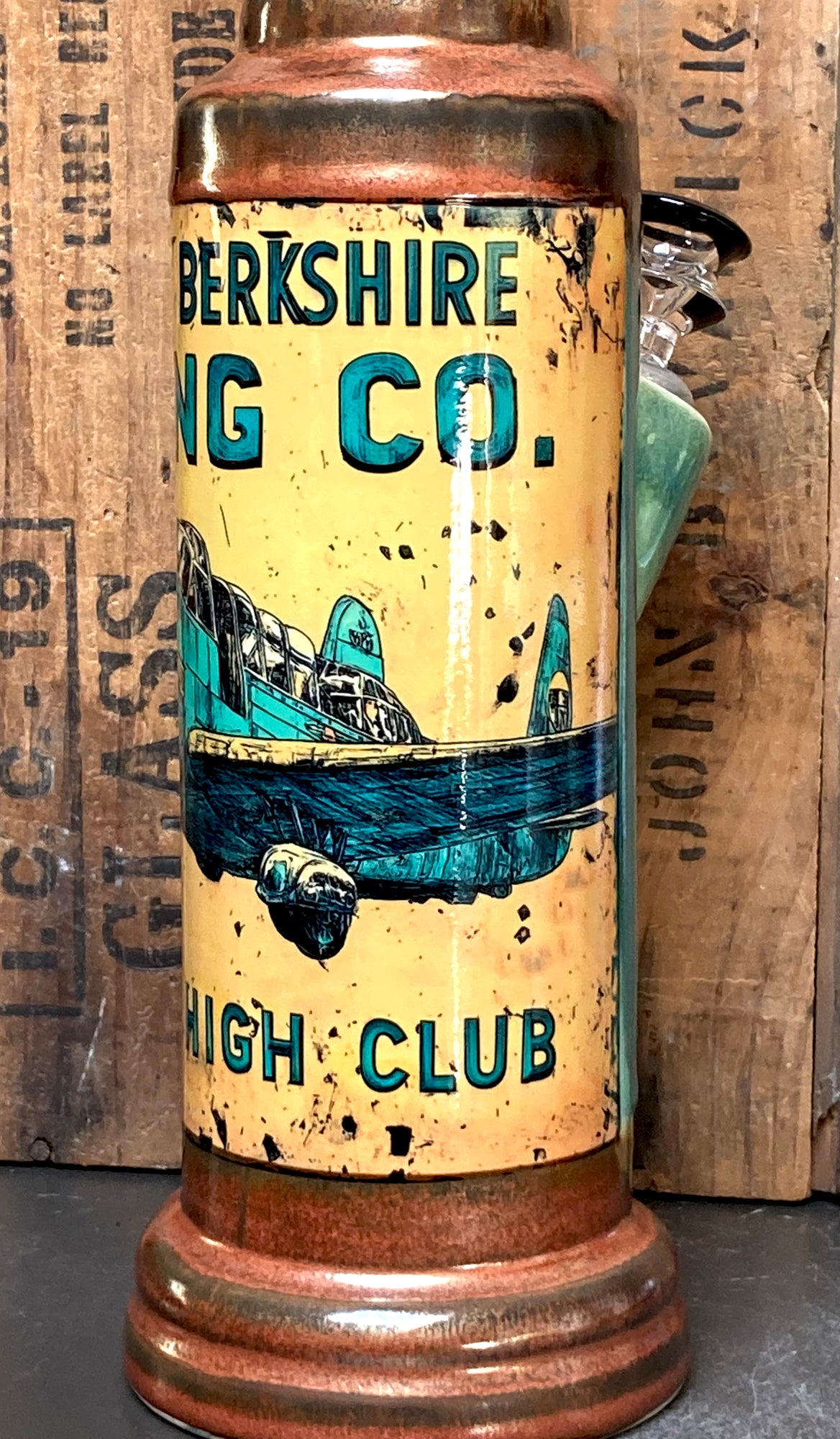 The Berkshire Bong Company Mile High Club branding and retro airplane art on bong.