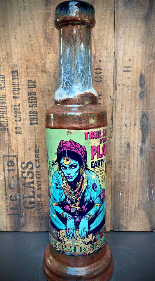 True Stories from Planet Earth Ceramic Bong with blue glazed bottle shape and colorful mystic woman label by Berkshire Bong Co