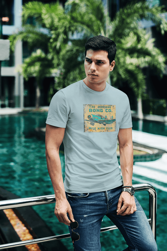 Faded green-blue-grey tee with cracked Mile High Club airplane graphic