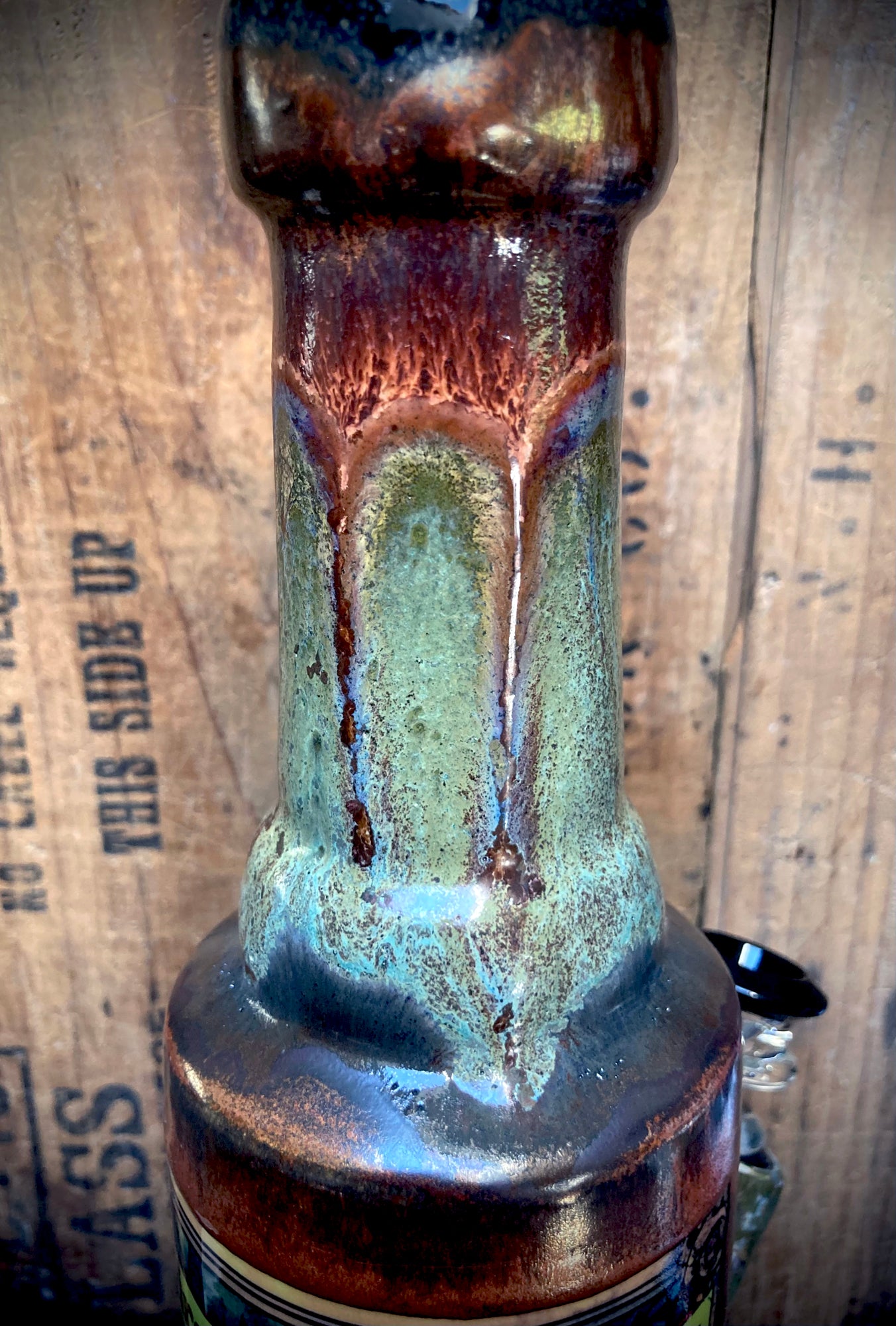 Forest turtle shell with amber, teal, and gold tones, detailed line work on ceramic bong
