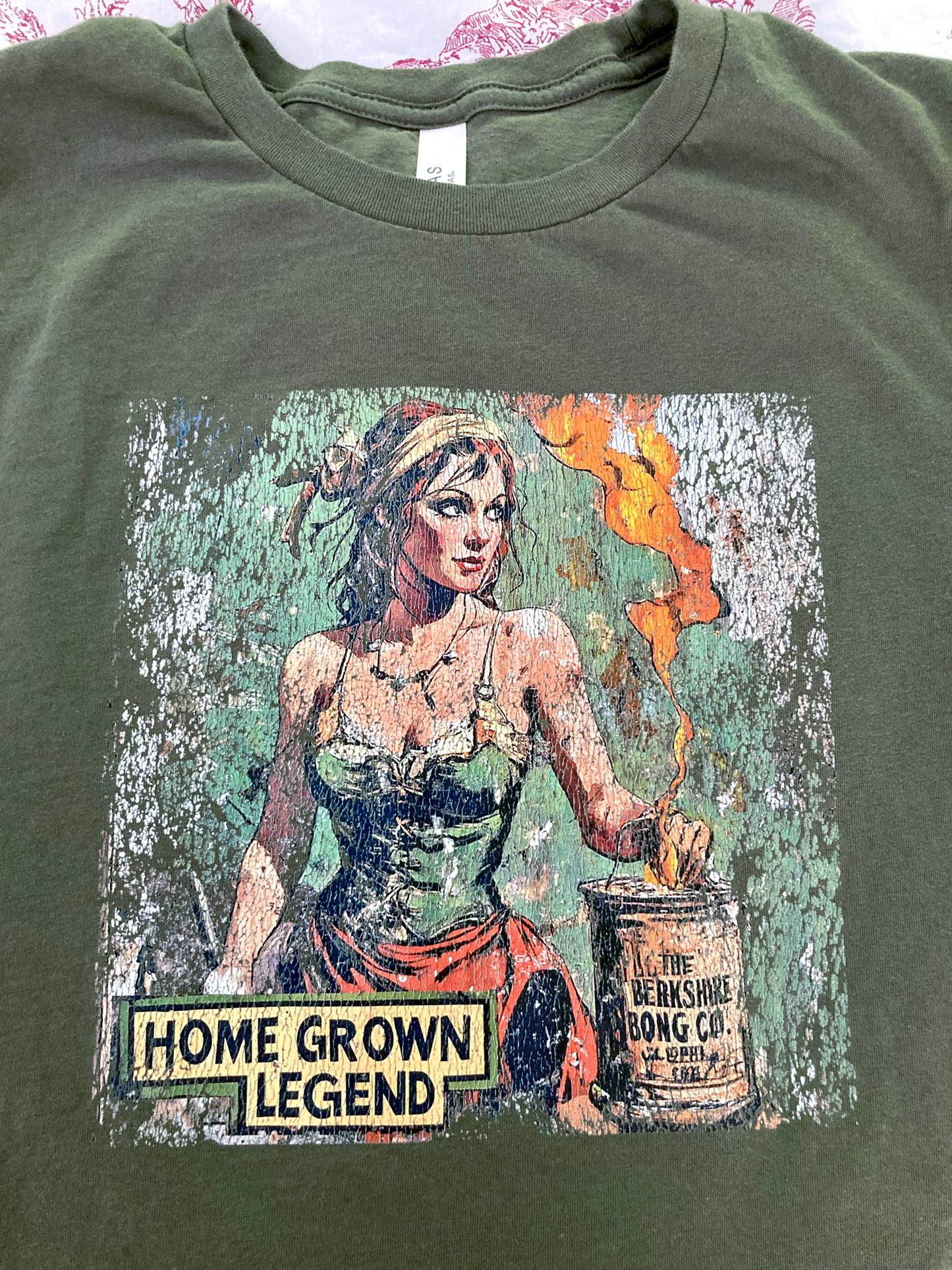Homegrown Legend Distressed Art Military Green T-Shirt featuring vintage distressed pinup artwork of a woman with jar and flame