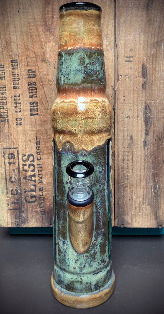 Graffiti-inspired ceramic bong featuring bold typography and weathered urban art textures.