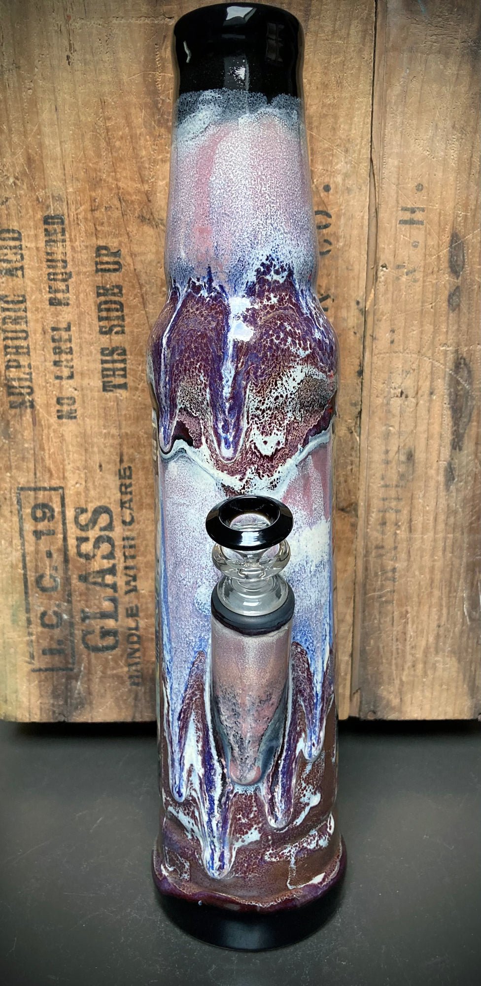 Ceramic bong with spiritual healer design in purple-white gloss glazes.