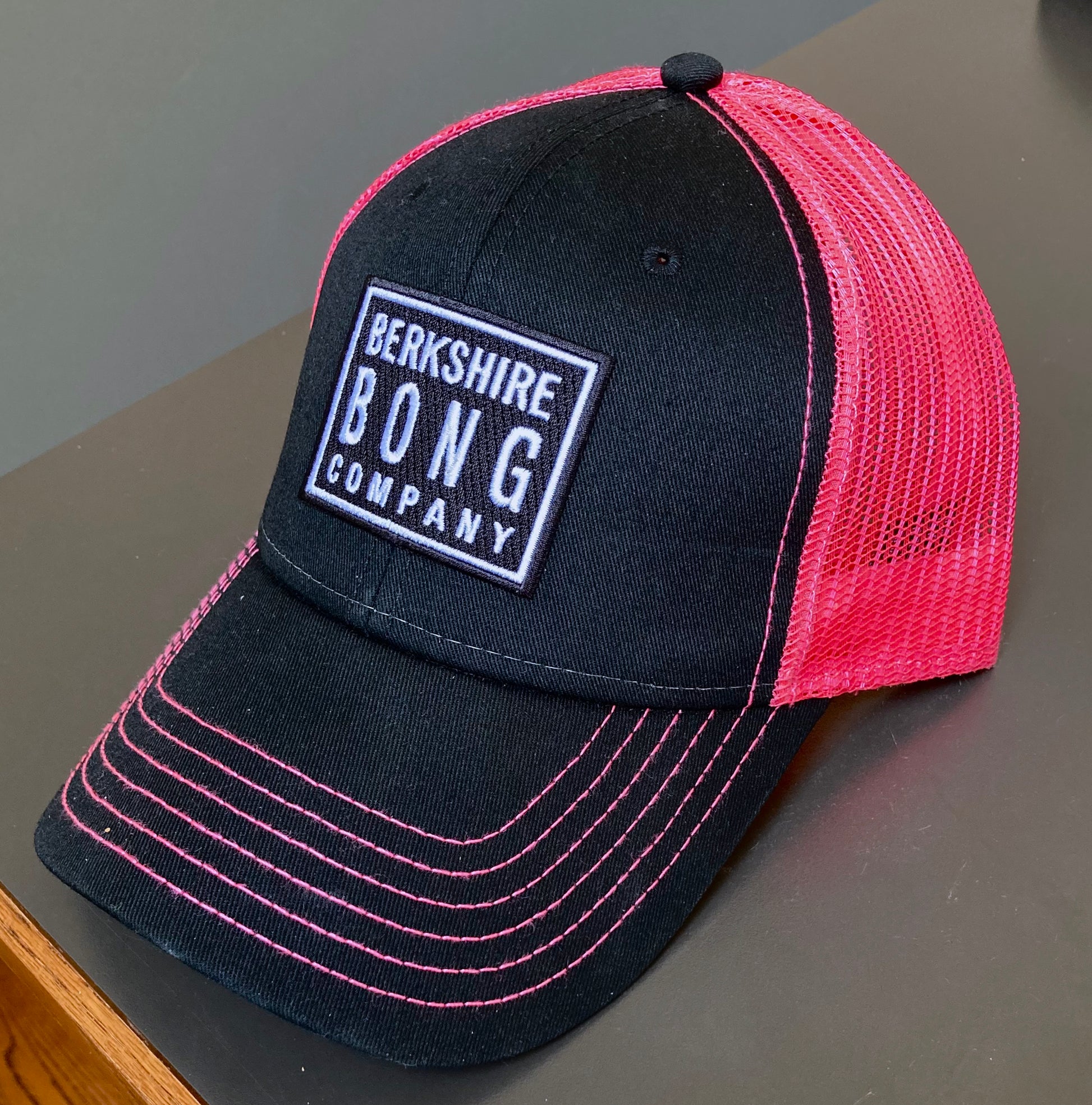 Berkshire Bong Company Trucker Hat featuring a black front and pink mesh back for a stylish look