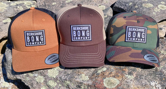 Berkshire Bong Company Trucker Hat in three styles: brown, tan, and camouflage designs
