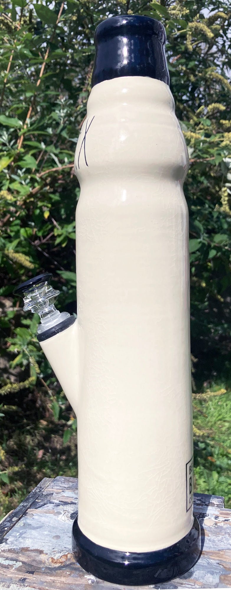 Stoneware Farmhouse Ceramic Bong RELAX tall cream ceramic bong with navy rim and glass downstem outdoors