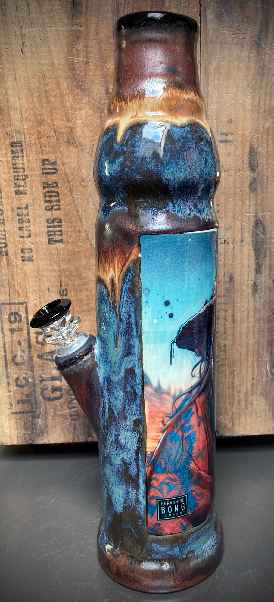 Father Time artwork on ceramic bong with blue, rust, and metallic copper finish.