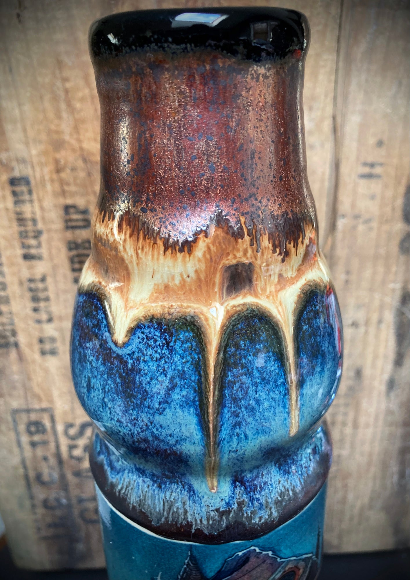 Handmade bong with old sage figure wearing wide-brimmed hat in rich glaze tones.