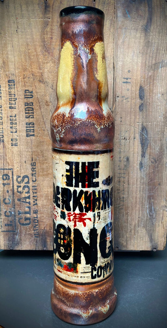 Handmade ceramic bong featuring graffiti tag art in black, red, and gold on white stoneware
