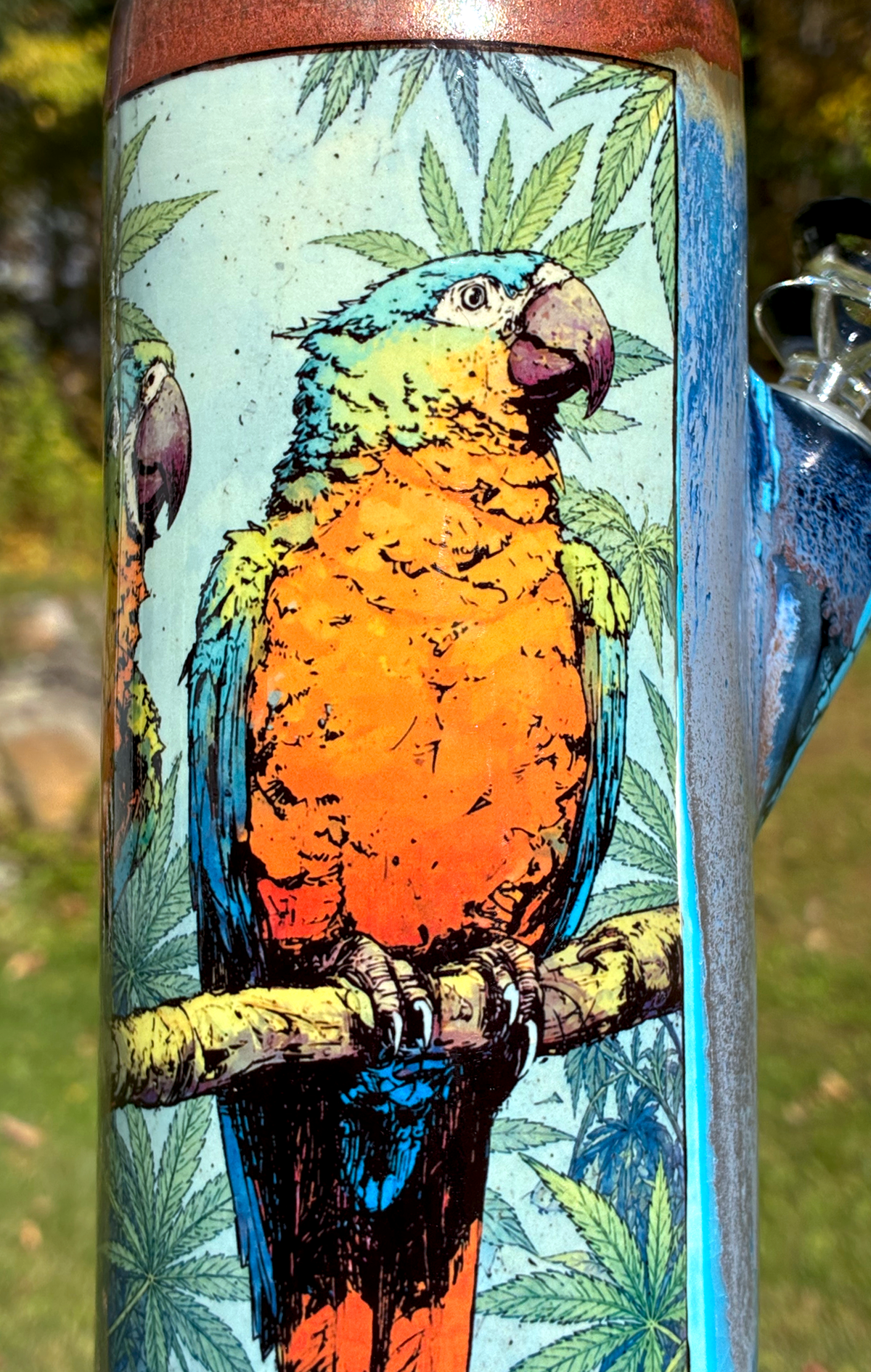Endless Summer handmade ceramic bong featuring colorful parrot artwork, sky-blue crackle glaze and metallic copper accents.