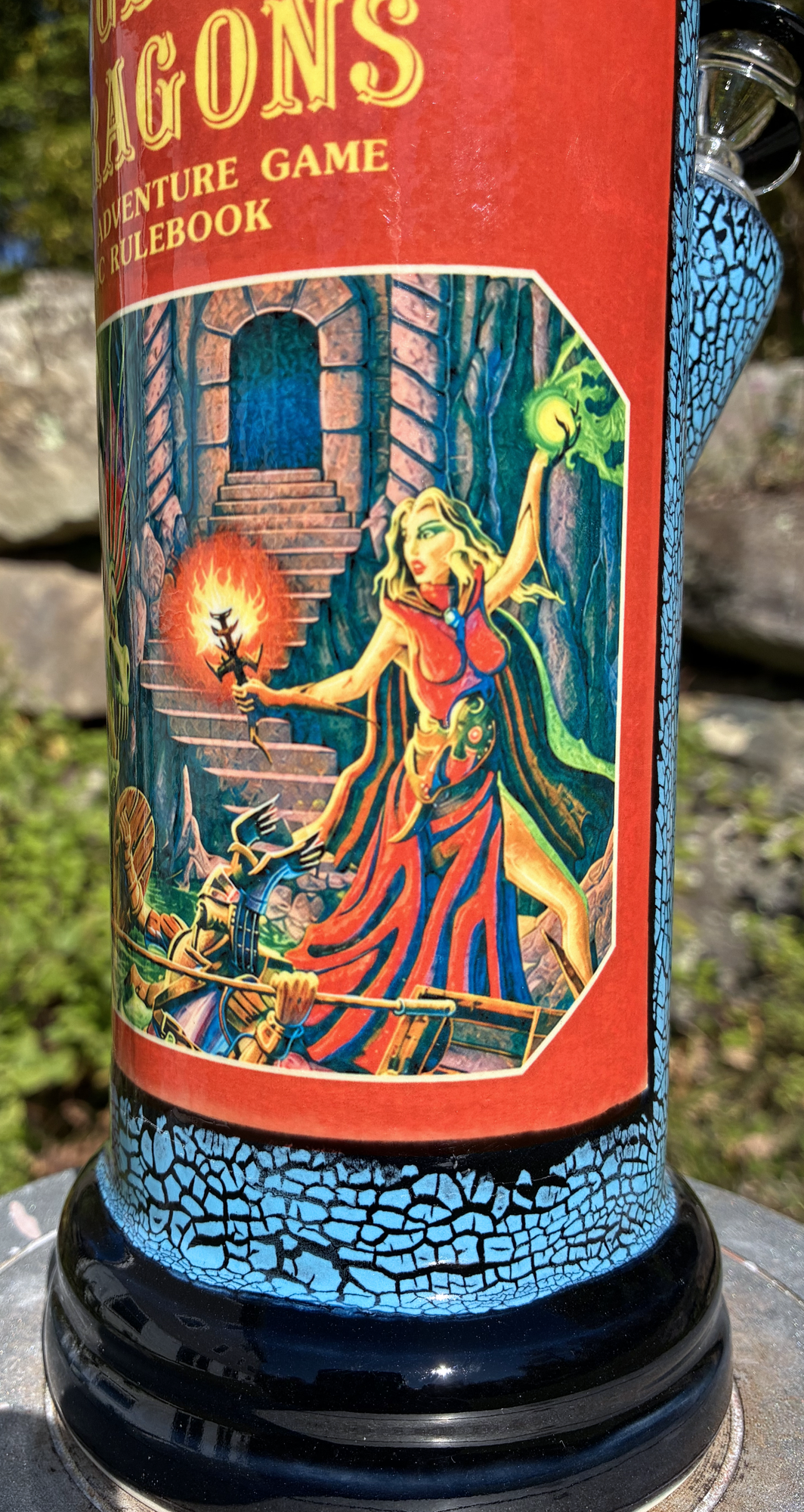 Handmade ceramic bong featuring classic Dungeons & Dragons red rulebook artwork, blue crackle glaze and glossy black accents.