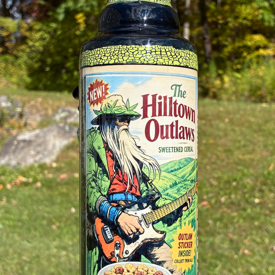 Hilltown Outlaws handmade ceramic bong featuring guitar playing Longbeard cereal box artwork, yellow and green crackle glaze and glossy black accents.