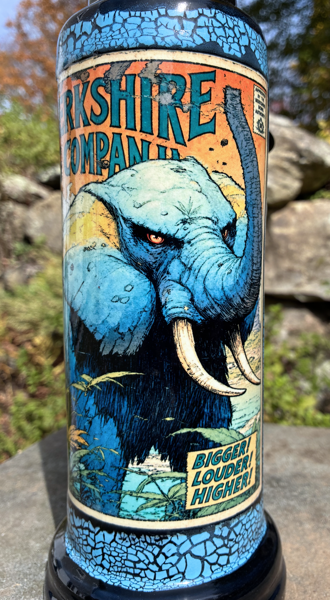 The Mighty Elephant handmade ceramic bong featuring vintage elephant comic-cover artwork, bright blue crackle glaze and glossy black accents.