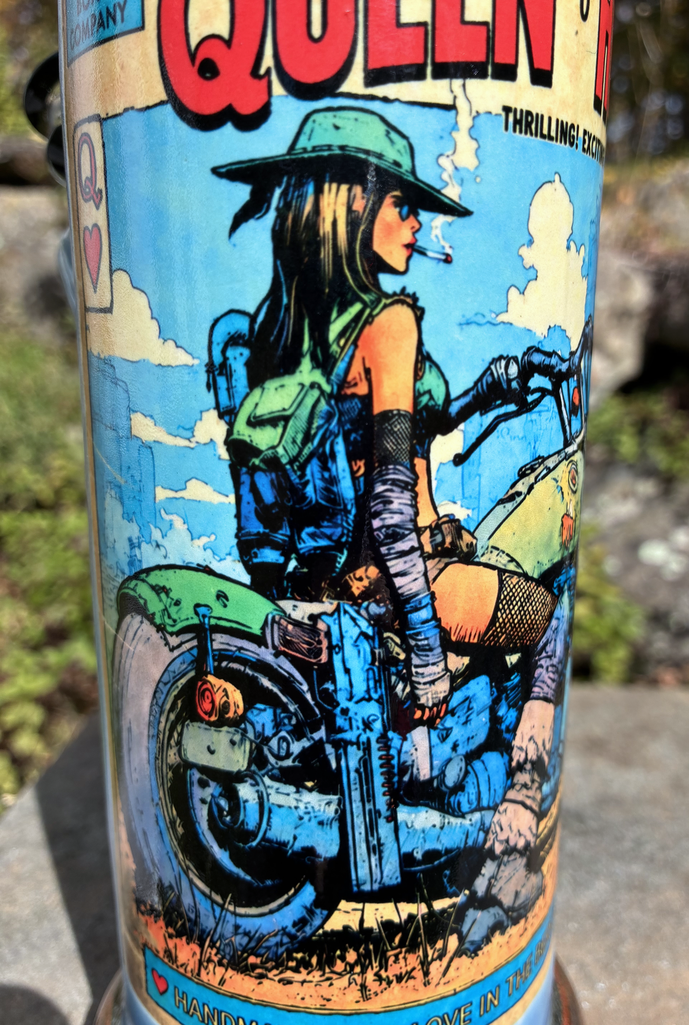 Queen of Hearts handmade ceramic bong featuring vintage biker playing-card artwork, flowing blue and turquoise glaze, and antique copper accents.