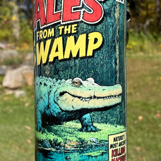 Tales from the Swamp handmade ceramic alligator bong featuring vintage comic-book artwork, blue crackle glaze and glossy black accents.