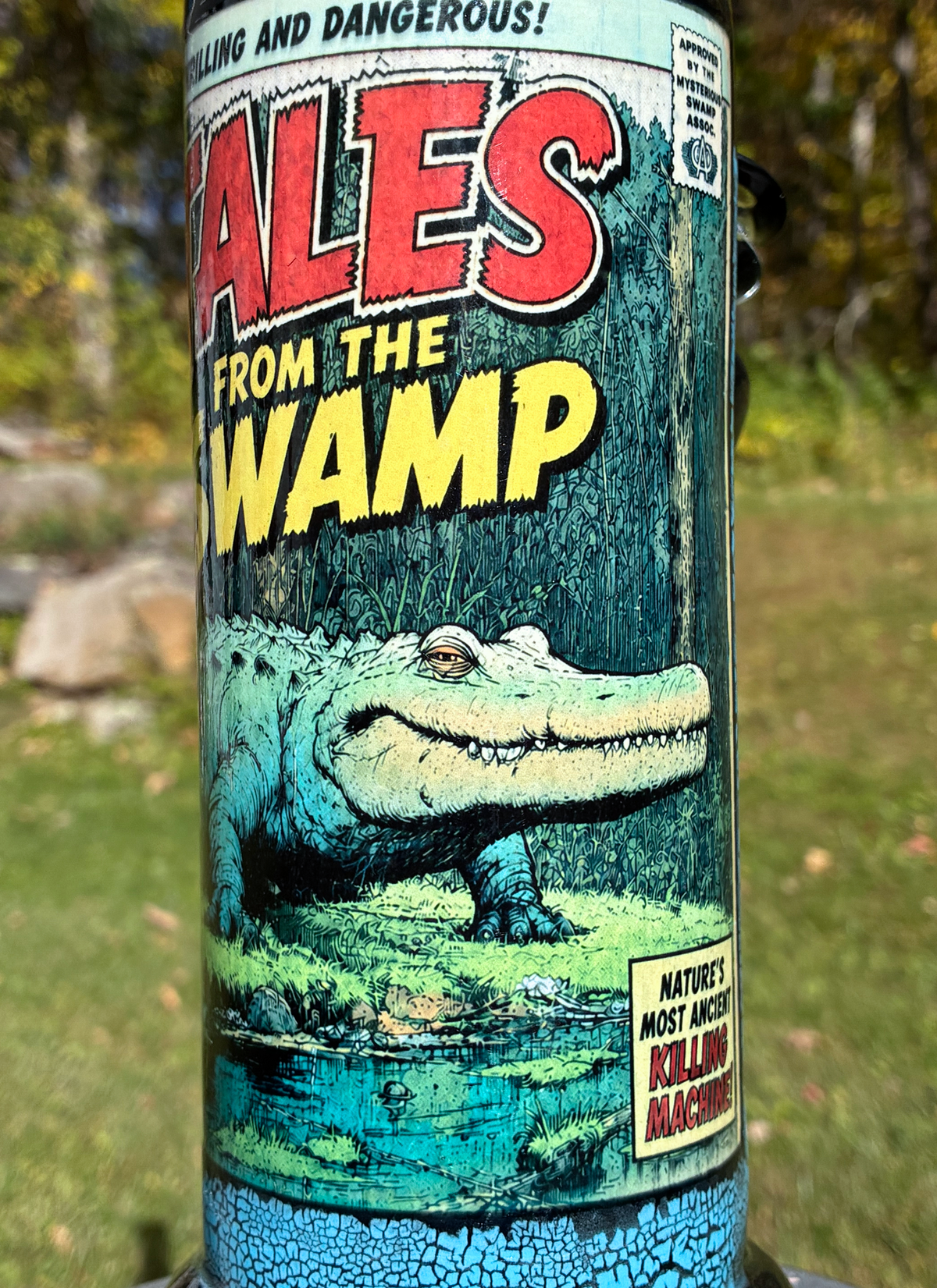 Tales from the Swamp handmade ceramic alligator bong featuring vintage comic-book artwork, blue crackle glaze and glossy black accents.