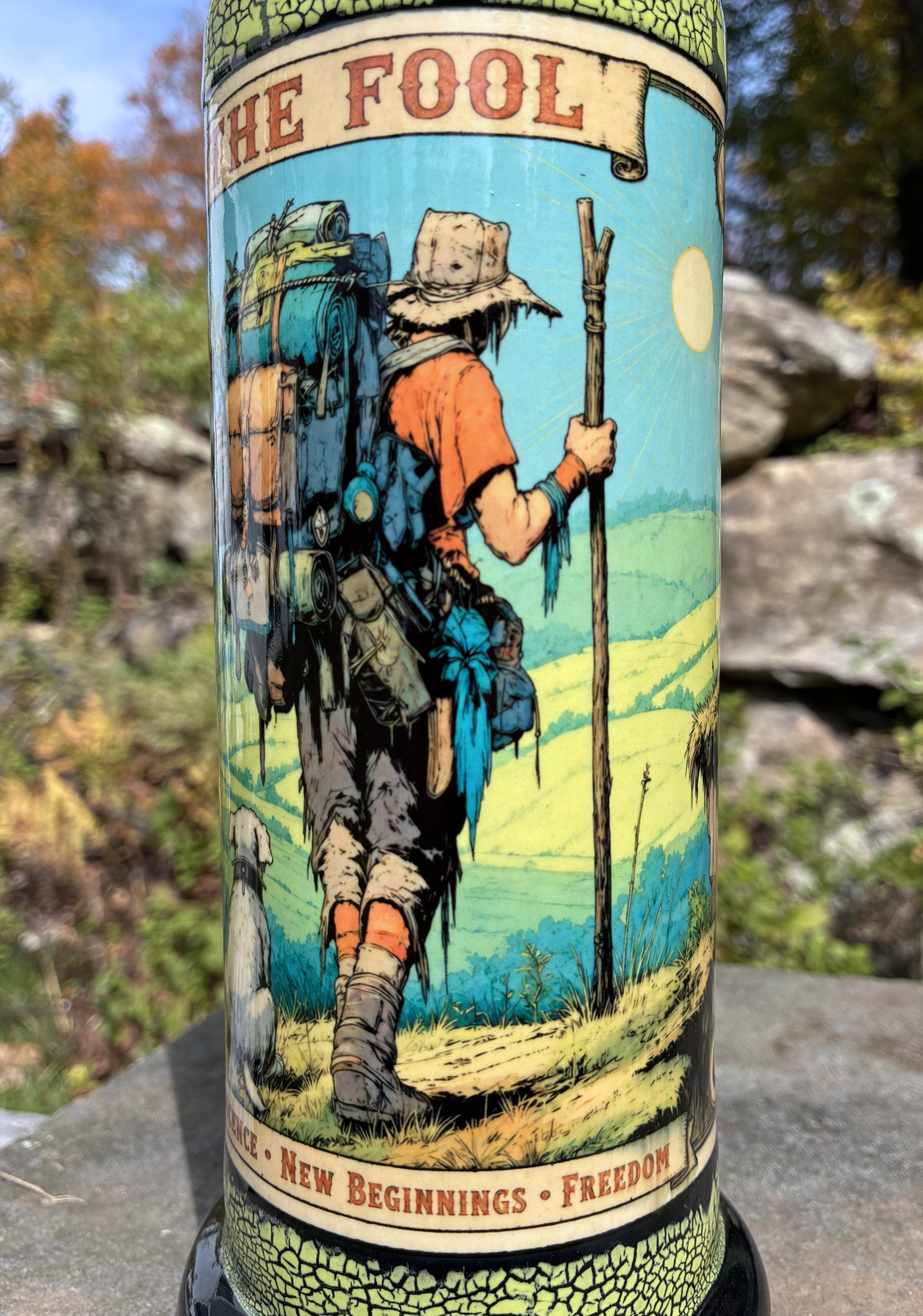 The Fool handmade ceramic tarot bong featuring a backpacking traveler and dog, neon yellow-green crackle glaze and glossy black accents.