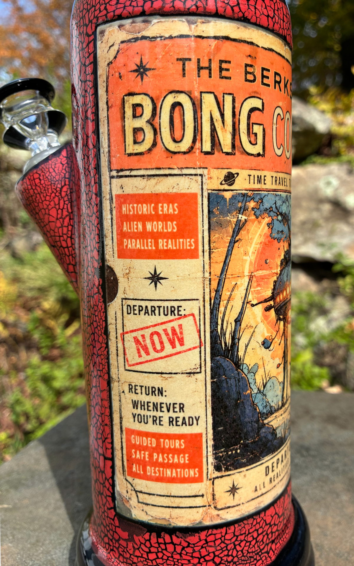 Time Travel handmade ceramic bong featuring vintage sci-fi ticket artwork with a traveler beneath a spacecraft, red crackle glaze and glossy black accents.