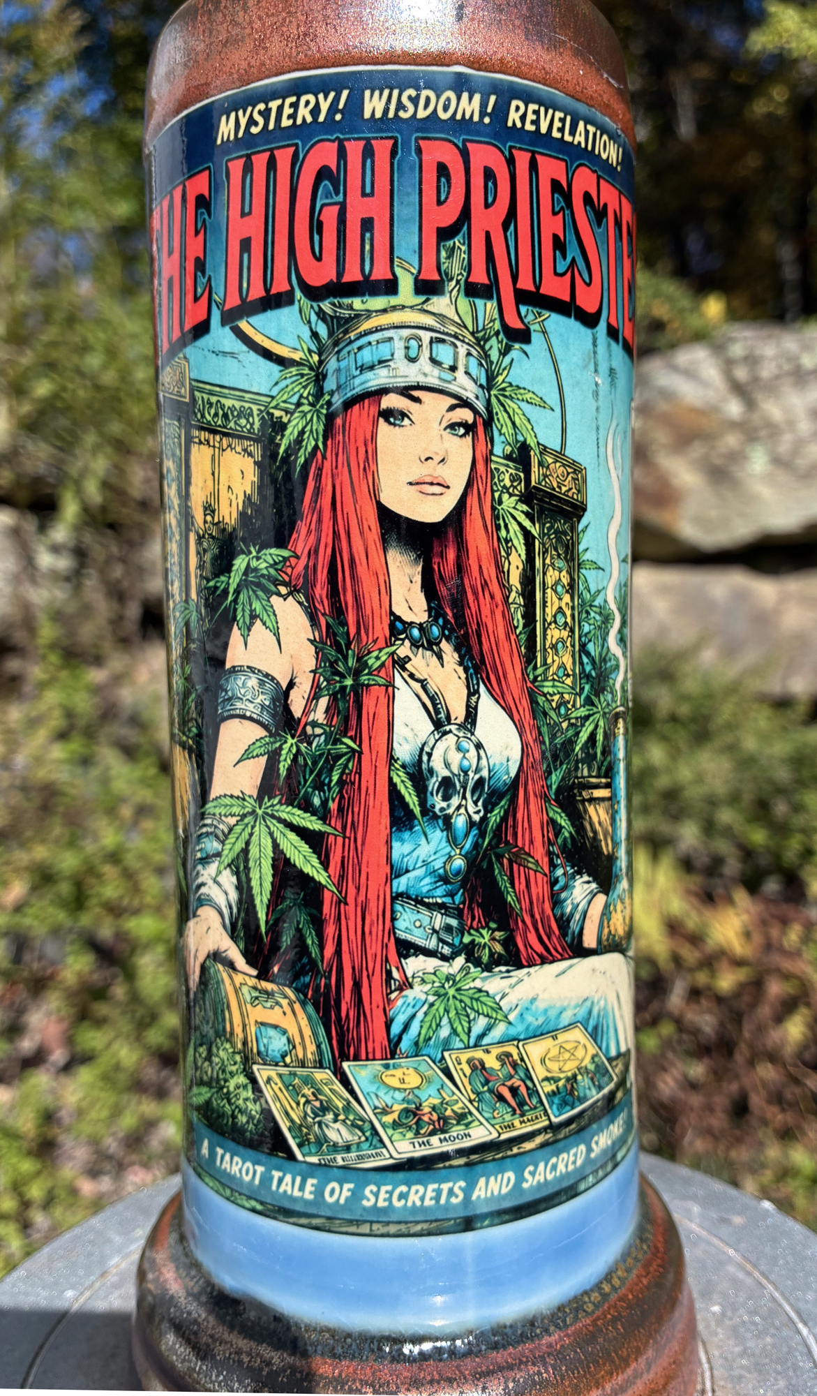 High Priestess handmade ceramic tarot bong featuring comic-cover artwork, flowing blue and creamy grey glaze, and metallic copper accents.