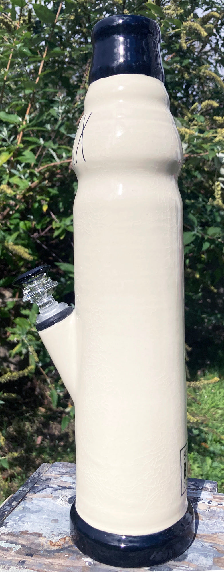Stoneware Farmhouse Ceramic Bong RELAX tall cream ceramic bong with navy rim and glass downstem outdoors